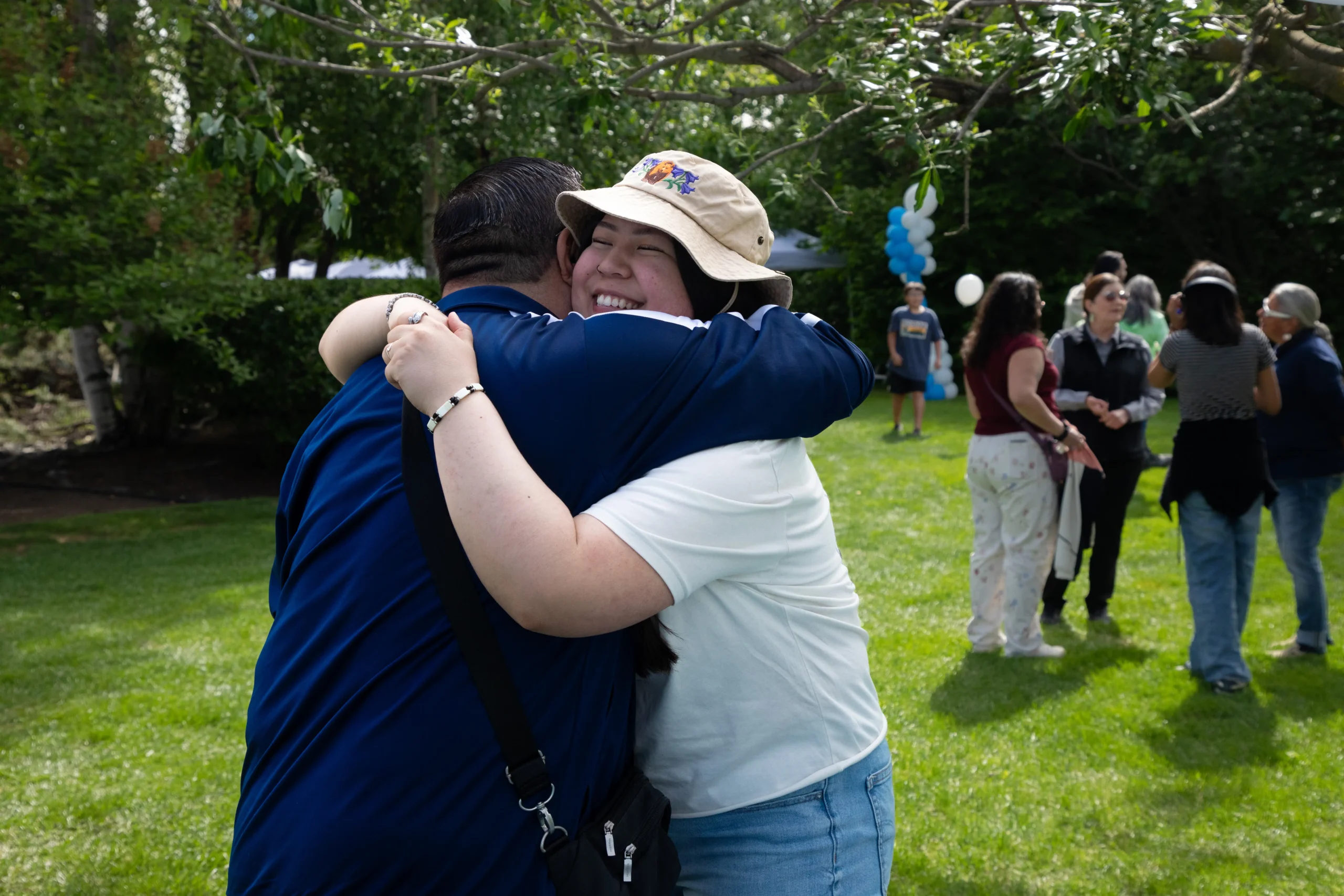 Woman hugging her grandfather at the Aleut Picnic