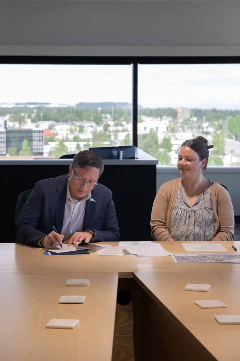 President & CEO, Skoey Vergen signing conveyance documents